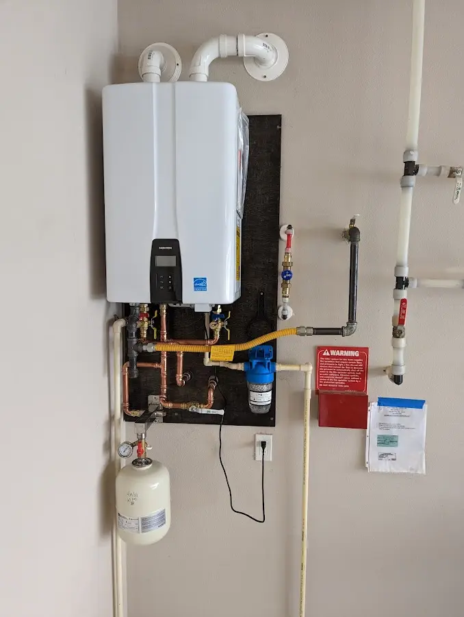 Professional plumber installing copper piping in a Lockeford home